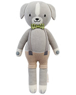Noah the Dog - Regular 20" by Cuddle + Kind is a knitted gray plush toy dog in a green checkered bow tie, tan shorts, and suspenders—a charming collectible plush for any NoahBirthday celebration.