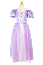 The Velvety Soft Princess Gown by Great Pretenders features puffed short sleeves, a crisscross bodice, and a sheer overlay—making it the perfect lavender and pink dress for any fairy tale or magical occasion.