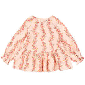 The Konges Slojd Baby Girls' and Girls' Coco Blouse is a light pink, long-sleeved muslin top with a floral print in pink and green, ruffled hem, and soft, breathable fabric for all-day comfort.