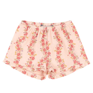 The Konges Slojd Baby Girls' and Girls' Coco Shorts feature a light pink floral print with small red and yellow flowers, an elastic waistband, ruffled hem, and breathable muslin for comfort.