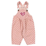 Konges Slojd Baby Girls’ and Girls’ Nola Sequin Overalls feature pink fabric with red heart patterns, a large sequined chest heart, adjustable shoulder straps, and logo buttons at the sides.