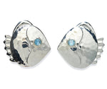 The Lizzie Fortunato Mikuni Stud Earrings are hammered silver, fish-shaped studs accented with blue semiprecious quartz eyes, shown on a white background.