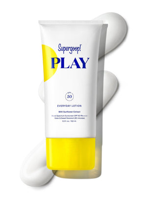 A tube of Supergoop Play Everyday Lotion SPF 50 with Sunflower Extract (5.5 fl oz) is shown with white lotion smeared in the background. The white tube features a yellow cap and blue and yellow text.
