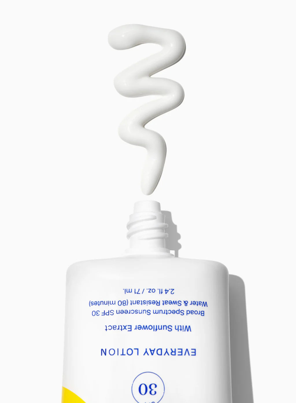 A tube of Supergoop Play Everyday Lotion SPF 30 with Sunflower Extract, 2.4 oz., with white lotion swirled above the opening, set against a white background.