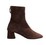 The Glove Suede Boot by Proenza Schouler is an elegant brown ankle boot with a comfortable block heel and a sleek back zipper.