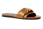 Proenza Schouler's Monogram Slide Sandals feature a gold buckle on a monogram-detailed strap and a sleek black sole.
