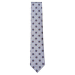 Starburst Tie by Robert Jensen: light blue silk, hand-stitched in Italy with red and blue circular motifs on a white background, shown against a plain backdrop.