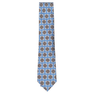 The Tiled Motif Tie by Robert Jensen features a light blue silk design with brown and white geometric squares—an elegant, refined menswear accessory.