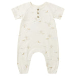 The Quincy Mae Baby Short Sleeve Jumpsuit features a cream color, three coconut buttons, a chest pocket, and a subtle animal and tree print—designed for babies with easy changing in mind.