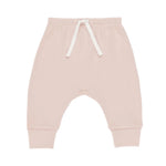 The Quincy Mae Baby Girls' Drawstring Pant features a light pink bubblegum hue, soft organic fabric, elastic waistband, and cuffed ankles for a relaxed fit, shown on a white background.