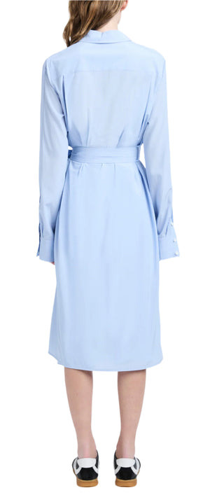 A person showcases their back in a light blue Proenza Schouler McKenna Dress, made from stretch silk viscose with a self-tie waist belt and concealed buttons, complemented by black and white shoes.