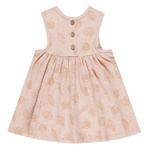 The Rylee & Cru Baby Girls' and Girls' Layla Dress is a sleeveless pink cotton jersey babydoll dress for toddlers, featuring a seashell pattern and three brown buttons on the back.