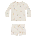 The Rylee & Cru Baby Boys' Rashguard Set includes a cream long-sleeve top and shorts with sailboat print, designed for comfort and offering UPF 50+ protection.