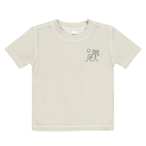The Rylee & Cru Boys' Rashguard is a beige short-sleeve tee with a wave, palm tree, and sun graphic on the left chest. It offers UPF 50+ sun protection, making it perfect for beach or pool play.