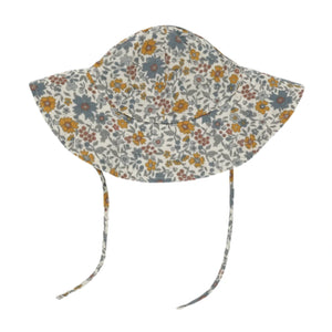 The Rylee & Cru Floppy Sun Hat features a wide brim, vibrant yellow, orange, blue, and brown floral print, and two chin-tying straps.