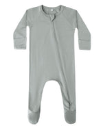 The Quincy Mae Baby Bamboo Zip Footie is a light gray, long-sleeve onesie with covered feet and an asymmetrical zipper from neck to left leg.