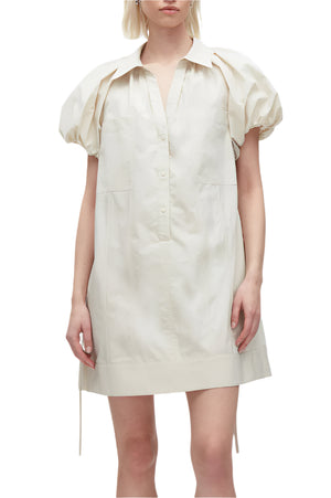 A person wears the 3.1 Phillip Lim Puff Sleeve Short Shirt Dress, featuring light beige color, an A-line silhouette, and lantern sleeves, against a plain white background.