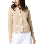 Woman in the Ann Mashburn Aubrey Cardigan with hand-crocheted trim, wearing white pants and standing neutrally.