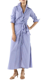 A woman wears the Ann Mashburn Maxi Tie-Waist Shirtdress in blue and white stripes with rolled sleeves and beige heeled sandals.