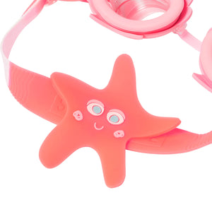 Close-up of Melody Mermaid Mini Swim Goggles by Sunnylife, featuring pink frames, a starfish-shaped decoration with a smiling face, and UV-protected lenses—perfect for kids’ pool adventures.