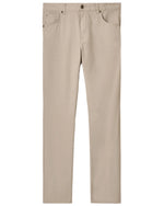 The Johnnie-O Atlas 5-Pocket Pant in beige offers comfort with its stretch twill fabric. These garment-dyed, lightweight pants feature a button and zipper fly, five pockets, and straight legs, showcased against a plain white background.
