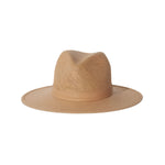 The Janessa Leone Simone Hat is a light brown, packable straw fedora with a flat crown and matching band, featuring a timeless wide-brimmed design shown on a plain white background.