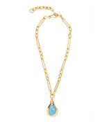 The Blue Pond Necklace by Lizzie Fortunato features gold-plated brass rectangular links and a teardrop shell pendant with a blue stone and central accent.
