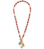 The Lizzie Fortunato Red Sea Necklace features alternating red and pink rectangular beads, gold accents, a standout turquoise bead, and a unique white irregular pearl pendant.