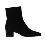 The Aimee Short Boot by Staud is a black suede ankle bootie featuring a sleek side zipper, a low block heel, and a pointed toe, viewed from the side.