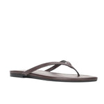 The Freja Thong by Staud features a flat sole and slim straps in supple rich brown nappa leather, set on a pristine white background.