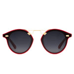 Krewe Nylon Sunglasses feature round dark flat nylon lenses, black and red frames, and a slim gold bridge, displayed against a white background.