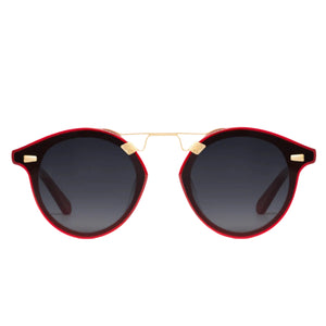 Krewe Nylon Sunglasses feature round dark flat nylon lenses, black and red frames, and a slim gold bridge, displayed against a white background.