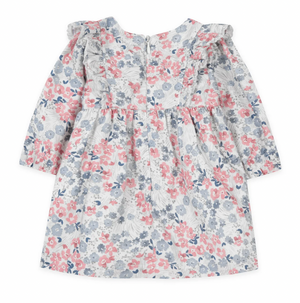 The Tartine et Chocolat Baby Girls' and Girls' Raspberry Printed Flowery Dress features a charming floral pattern with pink, gray, and blue flowers on a white background. Perfect for winter wardrobes, this elegant long-sleeve dress is ideal for any little one.