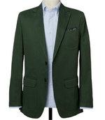 The Sid Mashburn Butcher Jacket, a green blazer crafted from hemp yarn with two buttons and three pockets, features a subtle checkered pocket square over a light blue striped shirt on a mannequin.