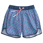 Johnnie-O Boys' Full Elastic Jr. Surf Red Fin Blue Fin Swim Shorts feature a blue, red, and white geometric pattern with navy trim and a white and red drawstring at the elastic waistband.