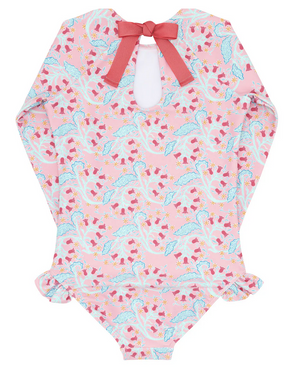 The Minnow Girls' Rashguard One Piece by Minnow is a sun-safe, long-sleeve swimsuit in a pink floral pattern, featuring a delightful keyhole back with a red grosgrain ribbon bow and ruffled leg openings for both style and protection.