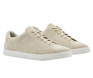 The Vantage Lite Suede Sneaker by Peter Millar, crafted from luxury beige suede, features a white EVA rubber outsole and is depicted from a slightly elevated angle.