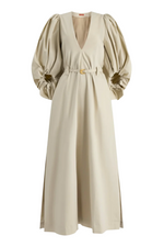 The Altuzarra Corrie Dress is a beige maxi with voluminous sleeves, a deep V-neck, belted waist, and side slits for a chic silhouette.