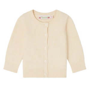 The Bonpoint Baby Girls' Teyana Cardigan features cherry motifs on cream-colored organic cotton, long sleeves, decorative stitching, and white buttons, shown laid flat against a white background.