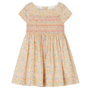 The Bonpoint Girls' Duchesse Smocked Dress is crafted from multicolor Liberty fabric, with short sleeves, a knee-length cut, and delicate smocking detail on the bodice.