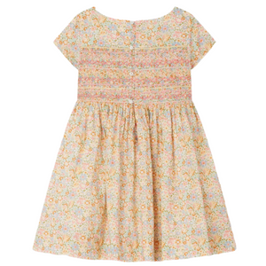 The Bonpoint Girls' Duchesse Smocked Dress is crafted from multicolor Liberty fabric, featuring short sleeves, a floral print, smocked bodice, and back buttons—perfect for young children.