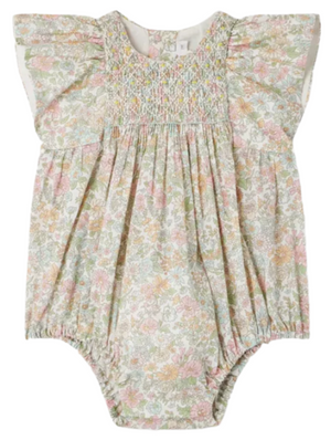 The Bonpoint Baby Girls' Edelili Smocked Romper, made with Liberty fabric, features flutter sleeves, hand-embroidered smocking, and a pastel pink, yellow, and green floral pattern for added charm and softness.