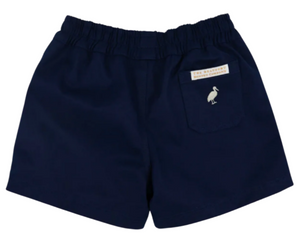 The Beaufort Bonnet Company Boys' Sheffield Shorts in navy blue feature an elastic waistband, a back pocket with a white bird icon and a label above it, all in the brand's signature Sheffield Shorts style.
