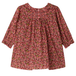 The Bonpoint Baby Girls' and Girls' Juju Smocked Dress, made with Liberty Fabrics in organic cotton, features long sleeves, chest smocking, gathered fabric, and a red, pink, and green floral print.