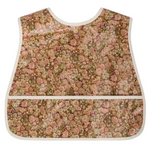 The Bonpoint Jlip Adjustable Bib, crafted from Liberty Fabrics with beige trim and a front pocket, is shown flat on a white background.