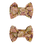 Two Miniclic hair clips by Bonpoint, crafted from pale pink Liberty fabric, arranged vertically on a white background. Perfect for adding a charming floral touch to any hairstyle.