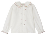 The Bonpoint Girls' Janeke Blouse features a ruffled embroidered collar, pleated details, button front, and gathered cuffs, crafted from soft organic cotton.