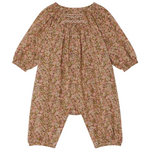 The Bonpoint Baby Girls' Jia Smocked Jumpsuit in Liberty Fabric features long sleeves, a pink and brown floral print, gathered neckline, elastic cuffs, hand-embroidered smocking, and snaps at the legs.