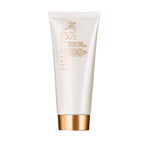 A white tube of Hampton Sun After Sun Body Lotion with gold accents and a skin-firming formula stands upright against a plain white background.