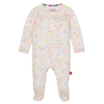 The Magnetic Me Baby Modal Footie is a long-sleeve, footed onesie made from eco-friendly TENCEL™ modal, featuring a pastel abstract face print, front snap buttons, and natural temperature regulation.
